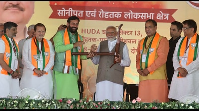 Haryana Chief Minister Nayab Saini gifting plough to Prime Minister Narendra Modi at Gohana in Sonepat on Saturday. (Manoj Dhaka/HT) Haryana Chief Minister Nayab Saini gifting plough to Prime Minister Narendra Modi at Gohana in Sonepat on Saturday. (Manoj Dhaka/HT)