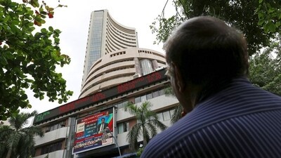 A man looks at a screen across a road displaying the Sensex on the facade of the Bombay Stock Exchange (BSE) building in Mumbai. (REUTERS)