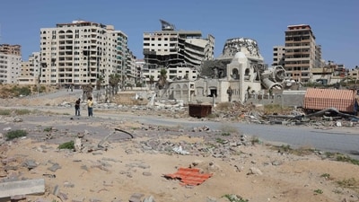 Palestinians walk past damaged and destroyed buildings in Gaza City on May 17, 2024 amid the ongoing conflict in the Gaza Strip between Israel and Hamas. (Photo by AFP) Palestinians walk past damaged and destroyed buildings in Gaza City on May 17, 2024 amid the ongoing conflict in the Gaza Strip between Israel and Hamas. (Photo by AFP)