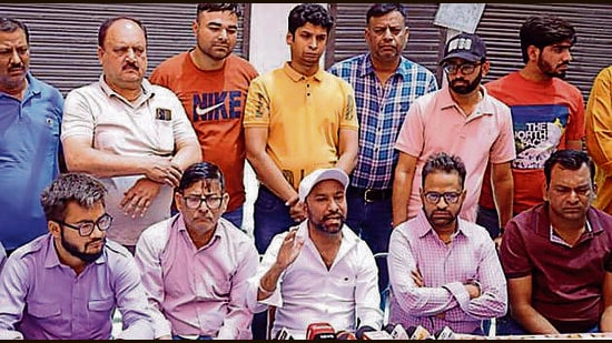 Local uniform suppliers and hosiery associations members addressing the media in Ludhiana on Saturday. (HT Photo)