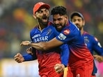 Royal Challengers Bengaluru's Virat Kohli (L) celebrates after taking a catch.