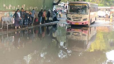 Commuters wait for bus at waterlogged Swargate ST depot on Sunday. They face the situation even before monsoon. (HT) Commuters wait for bus at waterlogged Swargate ST depot on Sunday. They face the situation even before monsoon. (HT)