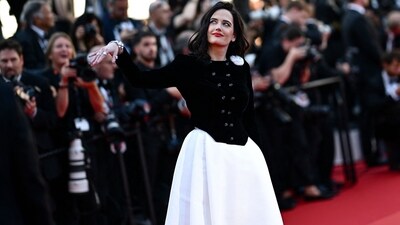 French actress and member of the Jury of the 77th Cannes Film Festival, Eva Green, stunned on the red carpet in Chanel Haute Couture. Her ensemble featured a black velvet fitted jacket, accented with a white faille camélia, and a white silk faille skirt. This custom creation by Virginie Viard was inspired by look 64 from the Chanel Fall 1994 Haute Couture collection. (Photo by LOIC VENANCE / AFP) French actress and member of the Jury of the 77th Cannes Film Festival, Eva Green, stunned on the red carpet in Chanel Haute Couture. Her ensemble featured a black velvet fitted jacket, accented with a white faille camélia, and a white silk faille skirt. This custom creation by Virginie Viard was inspired by look 64 from the Chanel Fall 1994 Haute Couture collection. (Photo by LOIC VENANCE / AFP)