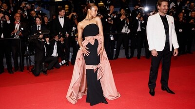 US actress Zoe Saldana embraced the bow trend with her stunning black strapless gown featuring a wrap-around pink train, off-shoulder neckline, bodycon fit and floor-sweeping hemline. (AFP) US actress Zoe Saldana embraced the bow trend with her stunning black strapless gown featuring a wrap-around pink train, off-shoulder neckline, bodycon fit and floor-sweeping hemline. (AFP)