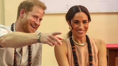 TOPSHOT - Britain's Prince Harry (L), Duke of Sussex, and Britain's Meghan (R), Duchess of Sussex, meet with children during their visit at the Lightway Academy in Abuja on May 10, 2024 as they visit Nigeria as part of celebrations of Invictus Games anniversary. (Photo by Kola SULAIMON / AFP) (AFP) TOPSHOT - Britain's Prince Harry (L), Duke of Sussex, and Britain's Meghan (R), Duchess of Sussex, meet with children during their visit at the Lightway Academy in Abuja on May 10, 2024 as they visit Nigeria as part of celebrations of Invictus Games anniversary. (Photo by Kola SULAIMON / AFP) (AFP)