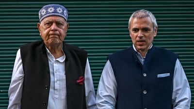 Jammu and Kashmir National Conference President Farooq Abdullah (L) along with his son and former Jammu and Kashmir chief minister Omar Abdullah (AFP)