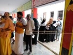 Voters queue at a polling station in Uttar Pradesh's Ayodhya.(HT photo)