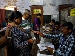 People get their names checked in voters' lists inside a polling station during the fifth phase of India's general election in Howrah district of West Bengal on May 20.(Reuters)