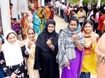 Voters showing finger ink mark after casting their votes at a polling booth during Lok Sabha election in Saran, Bihar.