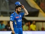 Mumbai Indians' Rohit Sharma adjusts his cap during the Indian Premier League (IPL) Twenty20 cricket match between Mumbai Indians and Lucknow Super Giants at the Wankhede Stadium in Mumbai