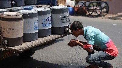 A man sprays cold water on his face in Ahmedabad. (REUTERS) A man sprays cold water on his face in Ahmedabad. (REUTERS)