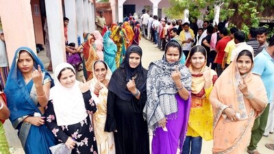 Voters showing finger ink mark after casting their votes at a polling booth during Lok Sabha election in Saran, Bihar. (Santosh Kumar/ Hindustan Times)