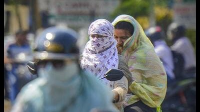 Commuters cover their faces for protection from the scorching heat in Jalandhar on Monday. (PTI) Commuters cover their faces for protection from the scorching heat in Jalandhar on Monday. (PTI)