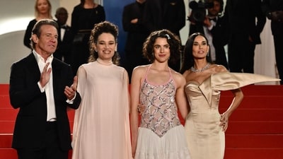Dennis Quaid, Coralie Fargeat, Margaret Qualley and Demi Moore arrive for the screening of the film The Substance. In the film, Moore plays a TV aerobics host who is let go because of her older age. She takes a new drug to become a younger version of herself, which is played by Margaret Qualley. (AFP)