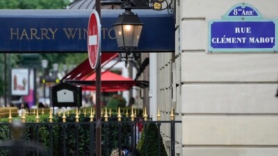 A Police forensic officer inspects the entrance of the Harry Winston jewelry after a robbery in Paris (AP) A Police forensic officer inspects the entrance of the Harry Winston jewelry after a robbery in Paris (AP)