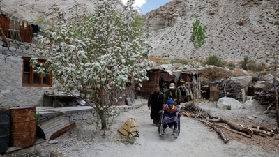 Lozbang Sherab, 75, head of the family, and his ailing wife Pustong Lamo, 85, head towards the polling booth to cast their votes, in Ladakh's remote Warshi village, home to just one family and five eligible voters, in Ladakh. (REUTERS)