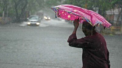 A pedestrian wades through a flooded street after heavy rains in Chennai. (AFP) A pedestrian wades through a flooded street after heavy rains in Chennai. (AFP)