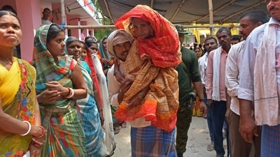 A man carries an elderly voter to cast her ballot at a polling station during the fifth phase of voting in India's general election, in Hajipur. (AFP) A man carries an elderly voter to cast her ballot at a polling station during the fifth phase of voting in India's general election, in Hajipur. (AFP)