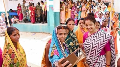 Jharkhand Mukti Morcha (JMM) candidate Kalpana Soren interacts with voters at a polling booth during the Gandey assembly seat by-polls in Giridih district, on May 20. (PTI)