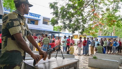 A BSF jawan stand guard as people wait in queues to cast their votes during the fifth phase of Lok Sabha elections, in Hooghly district. (PTI) A BSF jawan stand guard as people wait in queues to cast their votes during the fifth phase of Lok Sabha elections, in Hooghly district. (PTI)