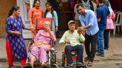 Elderly voters in wheelchairs show their inked fingers after casting votes for the fifth phase of Lok Sabha elections, in Mumbai. (PTI) Elderly voters in wheelchairs show their inked fingers after casting votes for the fifth phase of Lok Sabha elections, in Mumbai. (PTI)