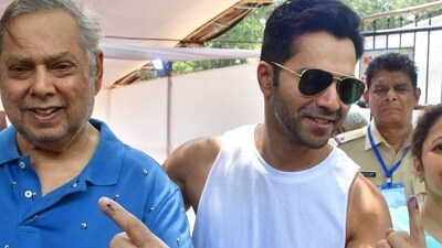 Varun Dhawan accompanied his father David Dhawan to the polling booth on Monday. Varun Dhawan accompanied his father David Dhawan to the polling booth on Monday.