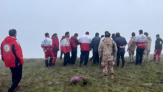 This frame grab from video released by the Iranian Red Crescent on May 20, 2024 shows members of a search and rescue team in Iran's East Azerbaijan province where Iran's President Ebrahim Raisi's helicopter was involved in "an accident".(AFP)