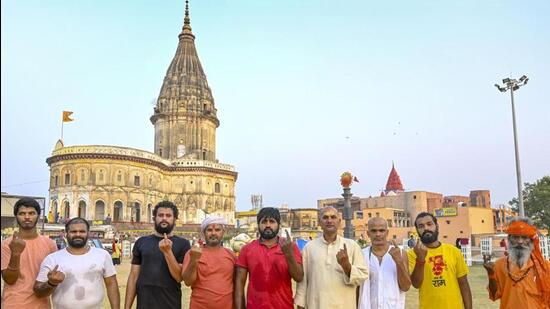 Priests show their inked finger after voting in Ayodhya. (PTI PHOTO)