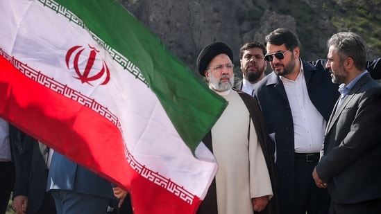 A handout picture provided by the Iranian presidency shows Iran's President Ebrahim Raisi (C) at the site of Qiz Qalasi, the third dam jointly built by Iran and Azerbaijan on the Aras River, ahead of its inauguration ceremony on May 19, 2024.&nbsp;(AFP)