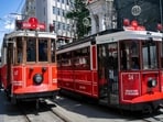 The pictures show a tram powered by traditional overhead power lines (REAR)(L) and a modern battery-powered electric tram (R) waiting at the stop on Istiklal Street, in Istanbul. The iconic red and white tram on Istiklal Street, beloved by tourists makes way for a more modern one while remaining true to the original aesthetics, in Istanbul.