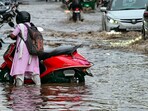 A commuter wades through a waterlogged road amid rain in Thiruvananthapuram. Kerala.