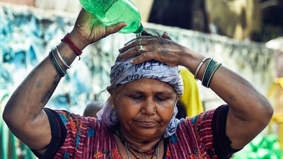 A woman pours water on her head to cool herself amid the ongoing heatwave, at the Swami Vivekananda Camp Chanakyapuri in New Delhi. (ANI) A woman pours water on her head to cool herself amid the ongoing heatwave, at the Swami Vivekananda Camp Chanakyapuri in New Delhi. (ANI)