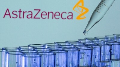 Test tubes are seen in front of a displayed AstraZeneca logo in this illustration. (Reuters)