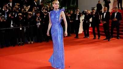 Diane Kruger graces the red carpet at the screening of the film “The Shrouds,” exuding elegance in a captivating Atelier Versace gown. The stunning ensemble, crafted in a mesmerising shade of blue, showcases sparkled fabric that shimmers under the lights. With its bodycon fit, warp pattern on the waist, and a floor-sweeping hemline, Kruger's attire radiates glamour. (REUTERS/Stephane Mahe)