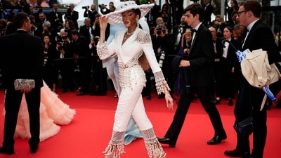 At the screening of the film “The Apprentice,” Canadian model Winnie Harlow makes a stunning entrance in a chic ensemble by Tamara Ralph Couture. Commanding attention on the red carpet, her attire includes a fringe-adorned jacket with intricate netted detailing, paired with matching pants. Completing her stylish look, Harlow adds an oversized hat and diamond jewellery for a touch of glamour. (Photo by Valery HACHE / AFP) At the screening of the film “The Apprentice,” Canadian model Winnie Harlow makes a stunning entrance in a chic ensemble by Tamara Ralph Couture. Commanding attention on the red carpet, her attire includes a fringe-adorned jacket with intricate netted detailing, paired with matching pants. Completing her stylish look, Harlow adds an oversized hat and diamond jewellery for a touch of glamour. (Photo by Valery HACHE / AFP)