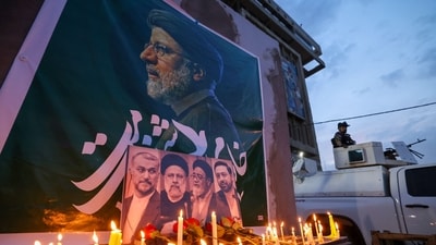 An Iraqi soldier stands guard next candles list by people paying their respects to Iran's late president Ebrahim Raisi outside the Iranian embassy in Baghdad (AFP) An Iraqi soldier stands guard next candles list by people paying their respects to Iran's late president Ebrahim Raisi outside the Iranian embassy in Baghdad (AFP)