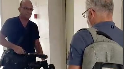 In this image from video, Israeli officials seize AP video equipment from an apartment block in Sderot, Southern Israel. (AP)