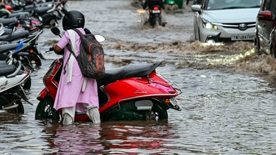A commuter wades through a waterlogged road amid rain in Thiruvananthapuram. Kerala. (PTI ) A commuter wades through a waterlogged road amid rain in Thiruvananthapuram. Kerala. (PTI )