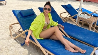 Bikini with a shirt? Yes, you heard right. Rakul Preet Singh's stylish beach look in neon attire is proof that she is a true fashionista. The diva wore an olive-hued bikini and paired it with an open-buttoned neon shirt. Styled with round-black sunglasses and golden hoop earrings, she exudes sartorial flair. (Instagram/@rakulpreet) Bikini with a shirt? Yes, you heard right. Rakul Preet Singh's stylish beach look in neon attire is proof that she is a true fashionista. The diva wore an olive-hued bikini and paired it with an open-buttoned neon shirt. Styled with round-black sunglasses and golden hoop earrings, she exudes sartorial flair. (Instagram/@rakulpreet)