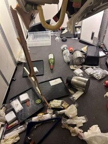 Water, coffee and alcohol and other food items strewn on the floor of the  Boeing 777-300ER plane. (Reuters)