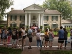 FILE - Fans wait in line outside Graceland Tuesday, Aug. 15, 2017, in Memphis, Tenn. A Tennessee judge on Wednesday, May 22, 2024, blocked the auction of Graceland, the former home of Elvis Presley, by a company that claimed his estate failed to repay a loan that used the property as collateral. (AP Photo/Brandon Dill, File)