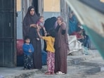 People look on as Palestinians inspect boats damaged in Israeli fire, amid the ongoing conflict between Israel and Palestinian Islamist group Hamas, in Rafah in the southern Gaza Strip May 22, 2024. REUTERS/Hatem Khaled