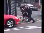 Snapshot of the police officer hitting the man on wheelchair. 