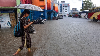 A commuter passes through a waterlogged bus station amid heavy rain in Kochi. (HT_PRINT) A commuter passes through a waterlogged bus station amid heavy rain in Kochi. (HT_PRINT)