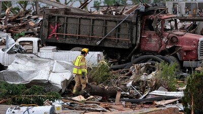 A firefighter walks among homes destroyed by a tornado Tuesday, May 21, 2024, in Greenfield, Iowa. AP/PTI(AP05_22_2024_000022B) (AP) A firefighter walks among homes destroyed by a tornado Tuesday, May 21, 2024, in Greenfield, Iowa. AP/PTI(AP05_22_2024_000022B) (AP)