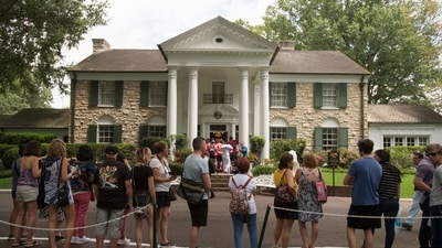 FILE - Fans wait in line outside Graceland Tuesday, Aug. 15, 2017, in Memphis, Tenn. A Tennessee judge on Wednesday, May 22, 2024, blocked the auction of Graceland, the former home of Elvis Presley, by a company that claimed his estate failed to repay a loan that used the property as collateral. (AP Photo/Brandon Dill, File) (AP)