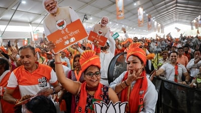 Bharatiya Janata Party's (BJP) supporters react as they hold cut-outs of India's Prime Minister Narendra Modi during his election campaign rally, in New Delhi. (Reuters)