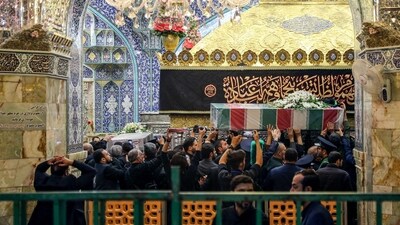In Qom, the procession moved toward the city's main shrine of Massoumeh as mourners waved the Shiite red flag and the yellow flag of the Iran-backed Lebanese Hezbollah group. (AFP)