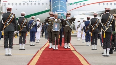 Honour guards carry the coffin of late president Ebrahim Raisi during a funeral procession at Mehrabbad Airport in Tehran on Tuesday. (AFP)
