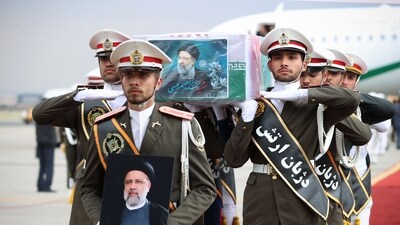 Waving Iranian flags and portraits of the late president, mourners marched through the northwestern city of Tabriz, the intended destination of Ebrahim Raisi's helicopter before it crashed. (AFP)